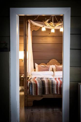 a bedroom with a bed with a canopy at Vollsnes Gjestehus in Stryn