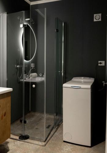 a bathroom with a shower and a toilet and a sink at Vollsnes Gjestehus in Stryn