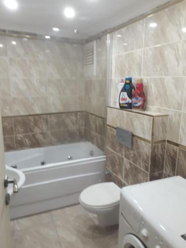 a bathroom with a tub and a toilet and a sink at Glory Suites in Istanbul