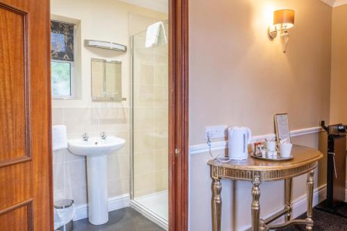 a bathroom with a sink and a shower at The Park Hotel - Sure Hotel Collection by Best Western in Diss