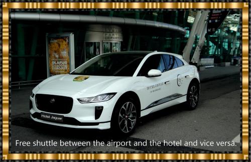 Hotel Jaguar Oporto - Airport to Hotel and City is a free Shuttle Service في بورتو: سيارة بيضاء متوقفة أمام مبنى