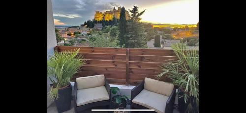 a balcony with two chairs and a view of a mountain at ZIN AND ZEN SUPERBE vue SPA SAUNA&JACUZZI in Vitrolles