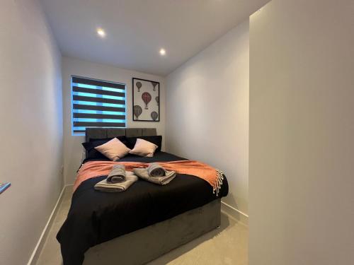 a bedroom with a bed with shoes on it at Star London Station Road 3-Bed Haven in London