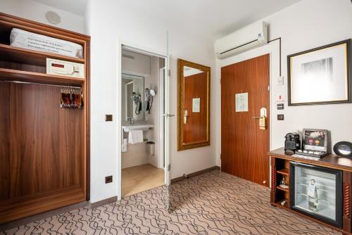 a corridor of a hotel room with a door at King's Hotel Center Superior in Munich