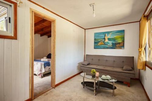 a living room with a couch and a table at Ko'ëtï Yahveh in Punta Del Diablo