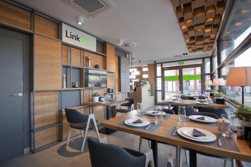 a dining room with wooden tables and chairs at Link Hotel in Tczew