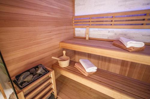 a sauna with wooden walls and wooden floors and towels at Nono Jure , private pool & sauna in Milna