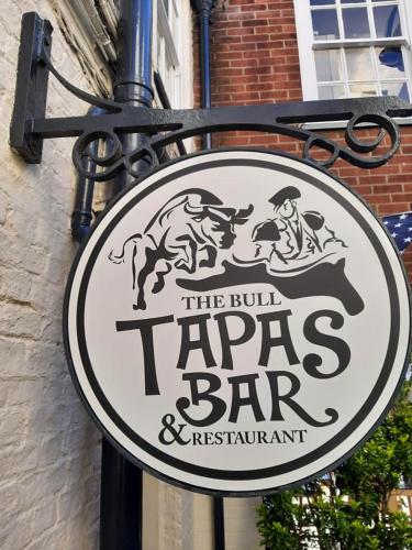 a sign for the bull tapas bar on the side of a building at The Bull Hotel in Horncastle