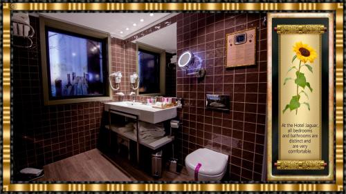 a bathroom with a sink and a mirror at Hotel Jaguar Oporto - Airport to Hotel and City Center and Vice-Versa is a Free and Continuous Shuttle Service from 7AM to 8PM in Porto