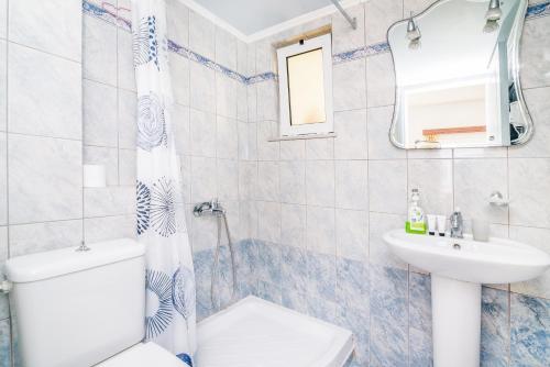 a bathroom with a toilet and a sink at Kalyves Bay in Kalyves