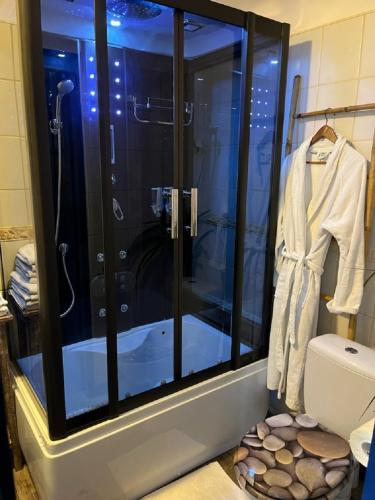 a bathroom with a shower with a glass door at Letnisko Dębki in Dębki