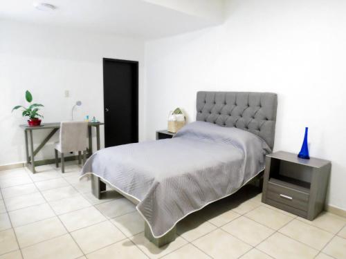 1 dormitorio con cama, tocador y mesa en Cozy And Pleasant House, en Ciudad de México