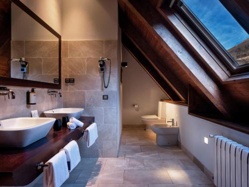 a bathroom with a sink and a toilet at Meliá de Tredós in Tredós