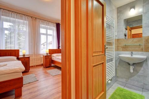 a room with a bathroom with a sink and a toilet at Penzion pod Radyni in Starý Plzenec