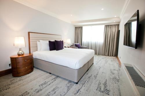 a hotel room with a bed and a window at Sanctum Maida Vale in London