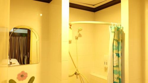 a bathroom with a shower and a mirror at Sea Boss Homestay in Kata Beach
