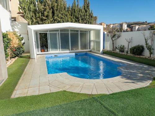 a swimming pool in the backyard of a house at Villa Maritim in Torrox