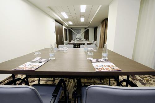 a conference room with a long table and chairs at Mercure Bucharest City Center in Bucharest