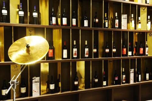 a room full of bottles of wine on shelves at Mercure Bucharest City Center in Bucharest