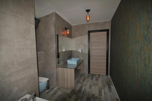 a bathroom with a sink and a shower and a toilet at Class Unique Beach in Marmaris