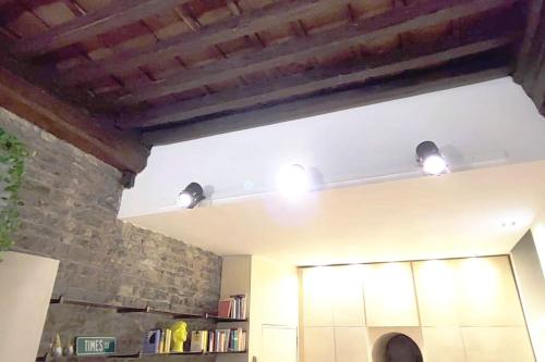 a kitchen with two lights on the ceiling at Appartamento Torre della Buca in Prato