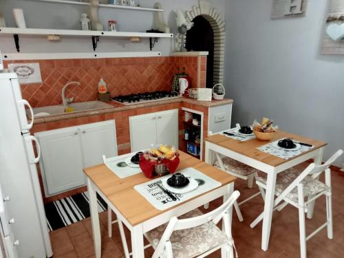 a kitchen with two tables and a kitchen with a sink at Ambrosia in Pozzilli