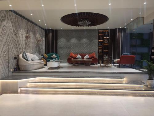 a lobby with couches and chairs in a building at THE PARKQUEEN in Rohtak