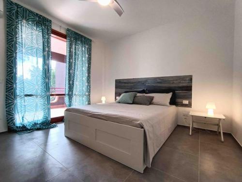 a bedroom with a bed and a large window at Blue Holiday da Marco in Letojanni