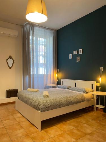 a bedroom with a bed and a blue wall at B&B La Terrazza Napoli in Naples