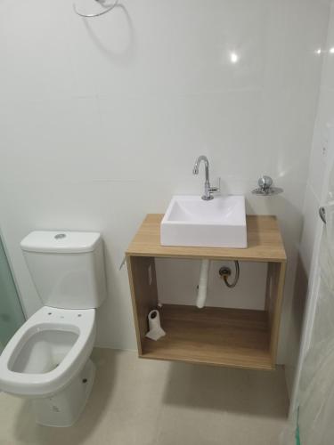 a bathroom with a sink and a toilet at Recanto Meia Praia in Itapema