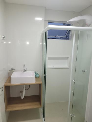 a bathroom with a sink and a shower at Recanto Meia Praia in Itapema