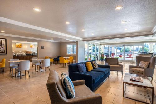 a living room with a couch and chairs and tables at Comfort Inn Gilroy in Gilroy