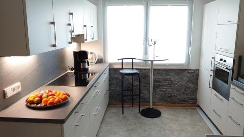 a kitchen with a bowl of fruit on the counter at Ferienwohnung Alter Weinberg in Saarburg