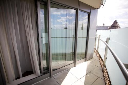 a balcony with sliding glass doors in a building at Sanctum Maida Vale in London