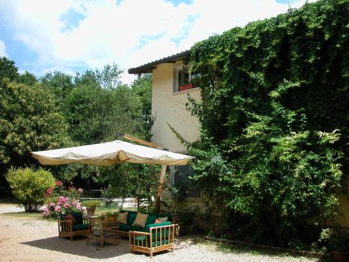 un patio con ombrellone, tavolo e sedie di Agriturismo San Lorenzo a Fiuggi