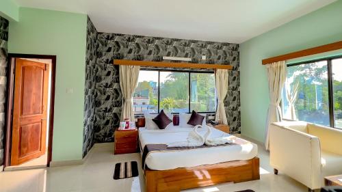 a bedroom with two beds and a window at THE FAME HOTEL in Jādabpur