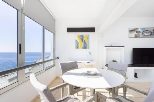 un salon blanc avec une table et des chaises blanches dans l'établissement Tranquilidad, playa y vistas al mar, à Callao Salvaje