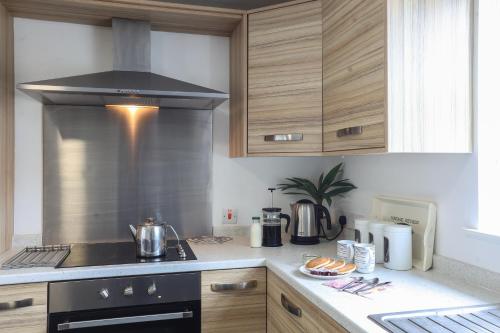 a kitchen with a stove top oven in a kitchen at GlenHaven Holiday Accommodation in Glenariff