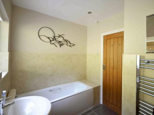 巴森斯韋特的住宿－Holly Bank，浴室配有白色浴缸、盥洗盆和卫生间。