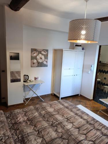 a bedroom with a large bed and a table at Casale la Decima in Budrio