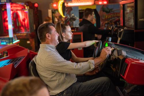 a man and a woman playing a video game at Kolping Holiday Resort in Hévíz