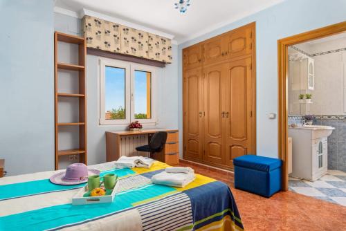 a bedroom with a bed and a bathroom with a sink at Villa Serena - PlusHolidays in Calpe