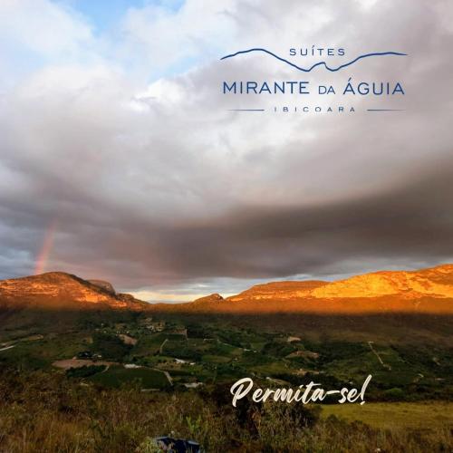 a sign that says miranda do acuula with a rainbow in the sky at Suítes Mirante da Águia in Ibicoara