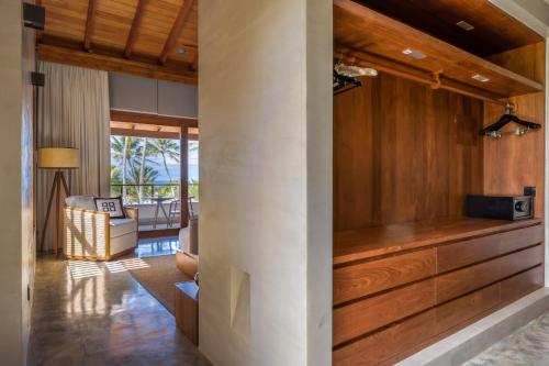 a living room with a wood paneled wall at Villa Thamburu, Bentota in Bentota