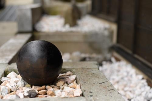 a black egg sitting on a pile of rocks at UFU Kanazawa in Kanazawa
