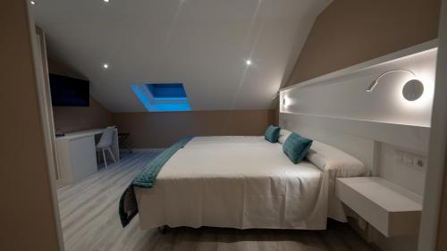 a bedroom with a bed in a small room at Hotel El Parador in Soto del Barco