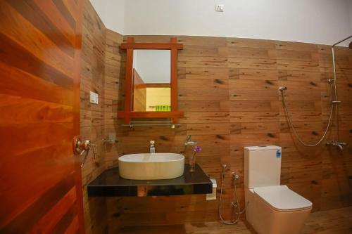 a bathroom with a sink and a toilet at Riverview Cabana Tissamaharama in Tissamaharama