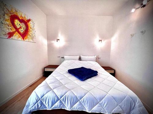 a bedroom with a bed with a blue pillow on it at Welcome Traveller AMORE APARTMENTS in Bardolino