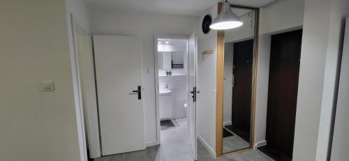 korytarz z lustrem i białymi drzwiami w obiekcie Siódme Niebo we Wrocławiu