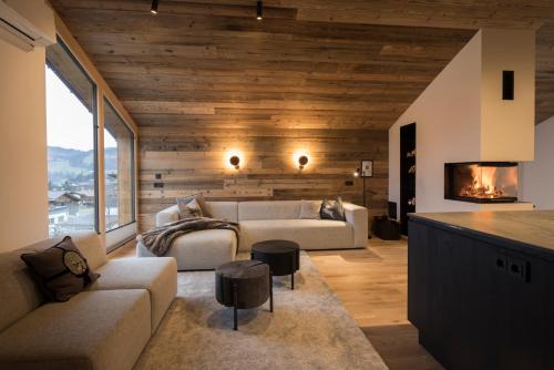a living room with a couch and a fireplace at Haus Sonnblick Chalet in Reith im Alpbachtal